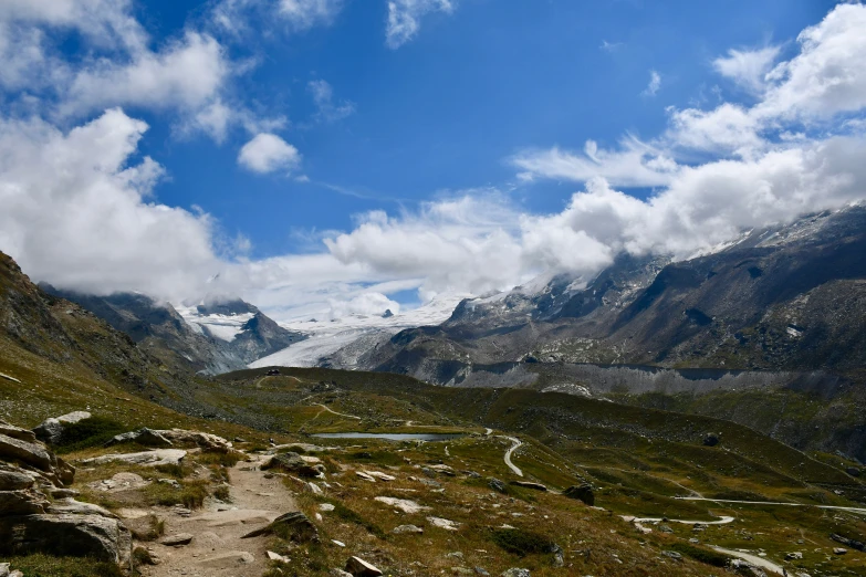 a trail through a vast valley and some mountains