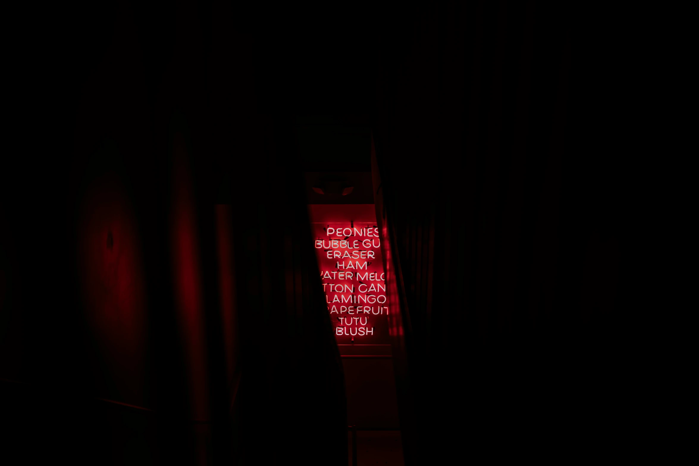 red neon sign lite up in a dark room