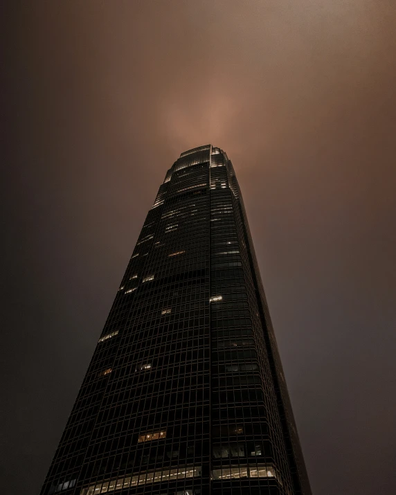 a view up into the top of an skyscr at night