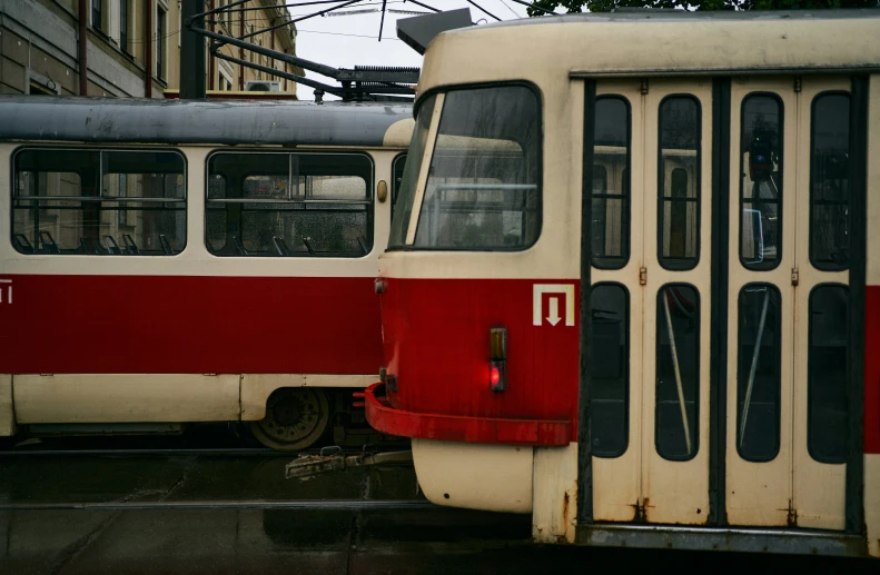 the old tram is parked next to the empty train car