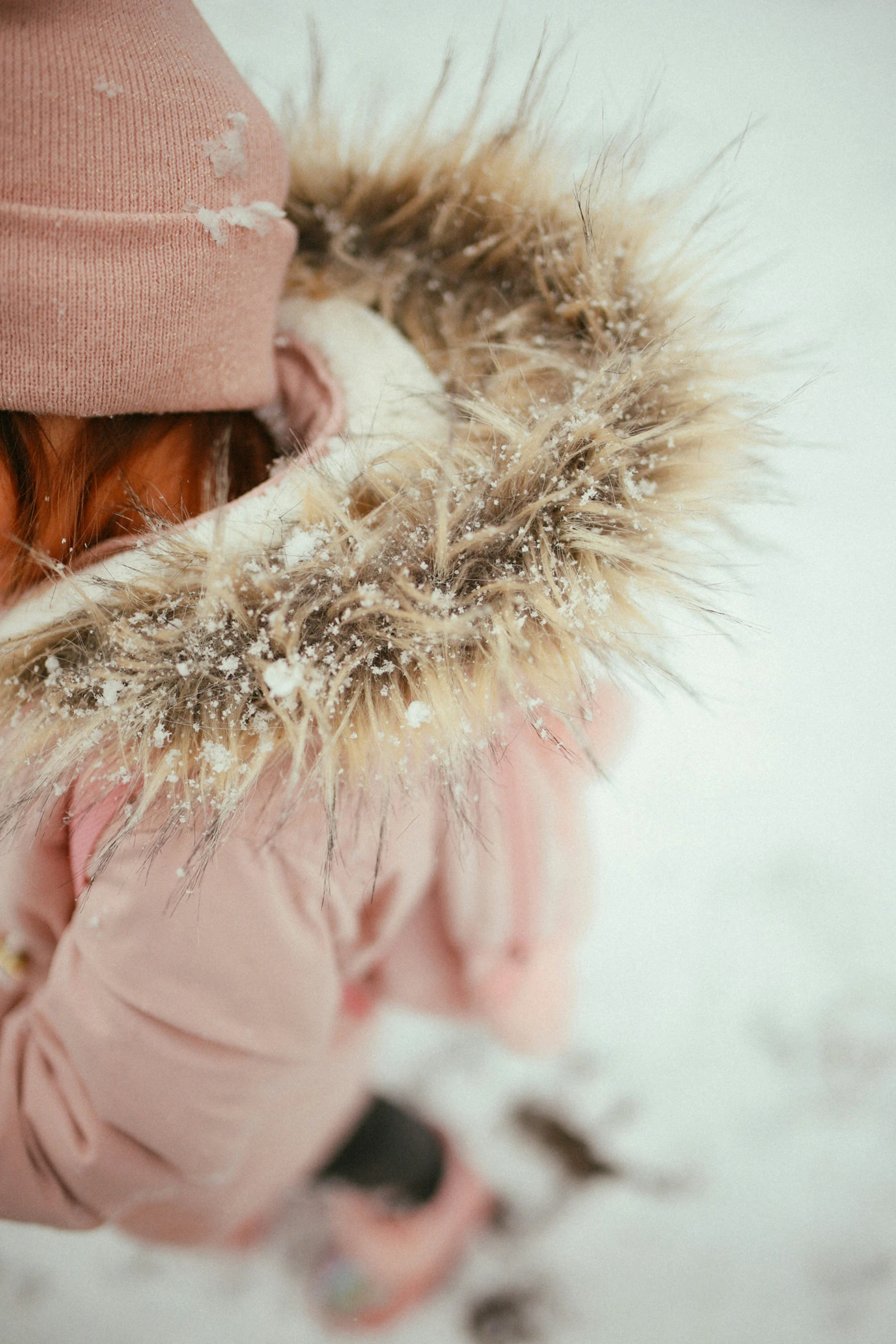 a close up of a person in winter clothing in the snow