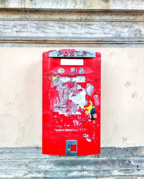 a red box with white paint on the side