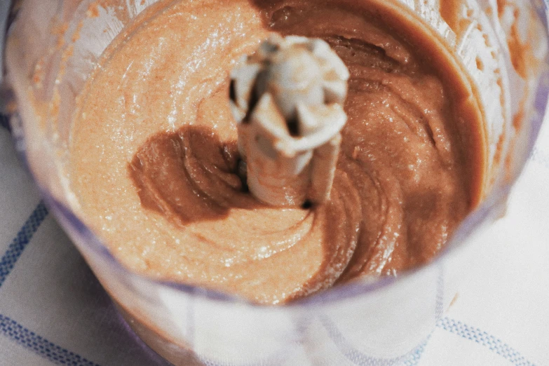 a nutella smoothie in the blender with brown and white liquid