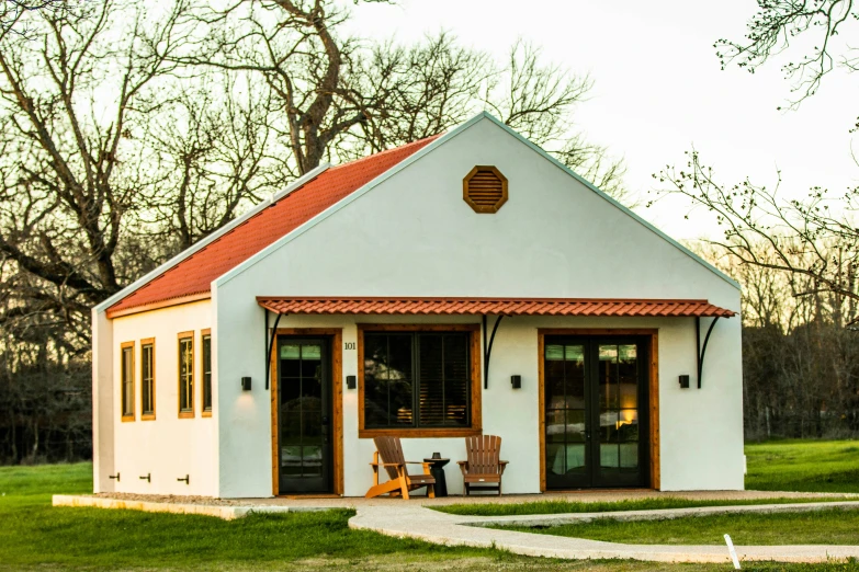 a small white building with two doors and one window