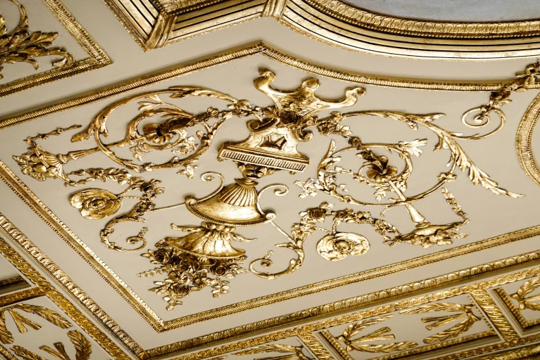 a ceiling that has some golden decorations on it