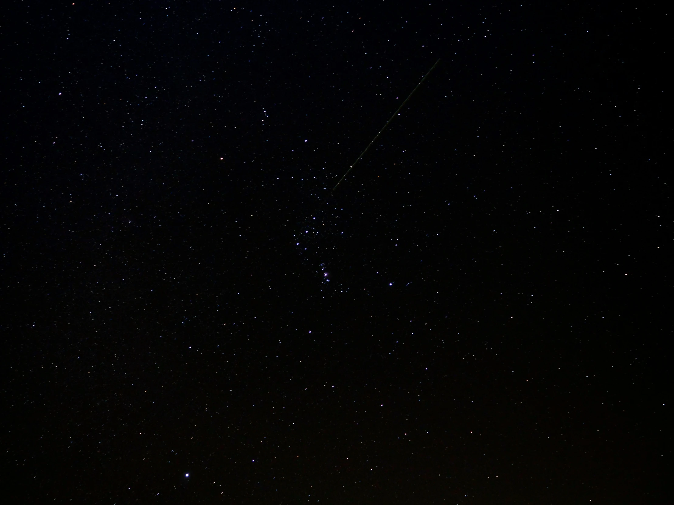 a black sky with stars and some clouds