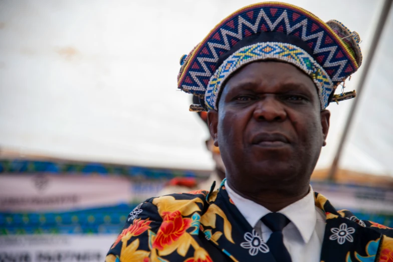 this man has a unique headdress with flowers