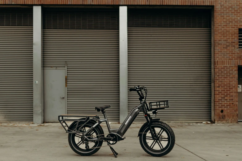 an electric bicycle parked in front of roller doors