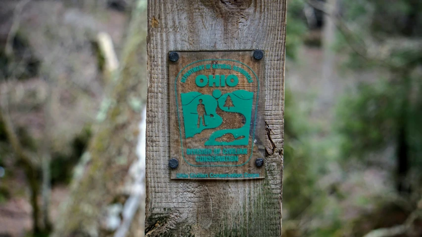 a wooden sign on a pole showing the number twenty one two