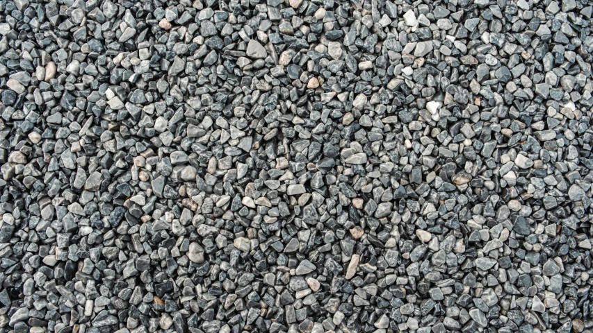 some rocks and gravel next to a wall