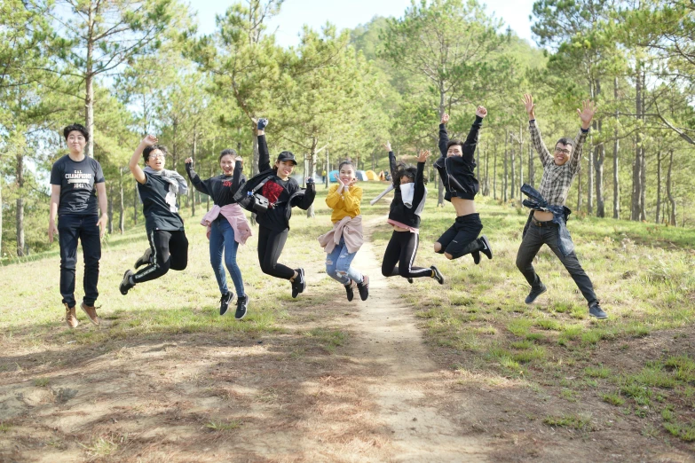 a group of people jump in the air to catch soing in the air