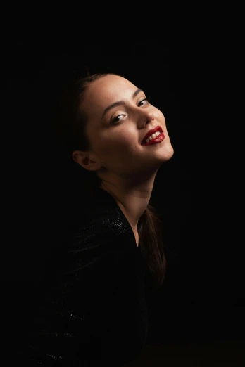 woman with her eyes closed, black background