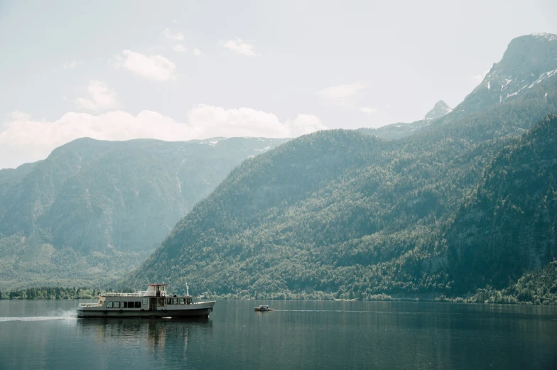 a big boat on the lake near mountains