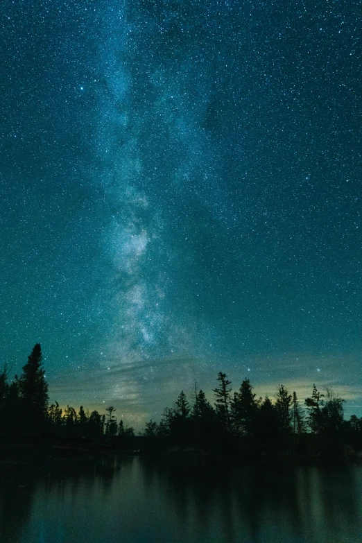 the night sky above a lake filled with water