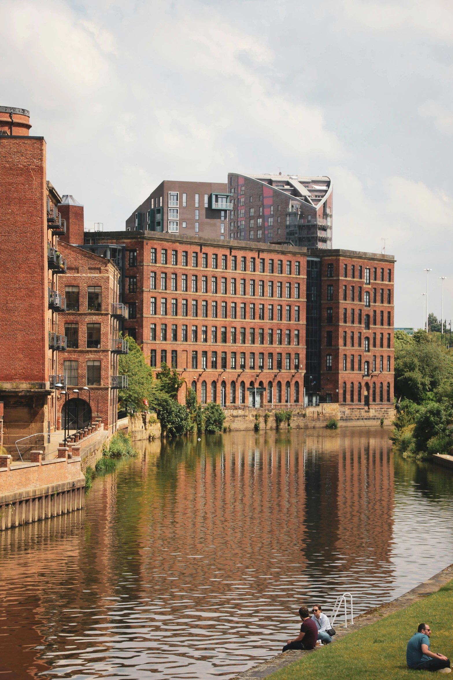 there is an old red brick building on the water