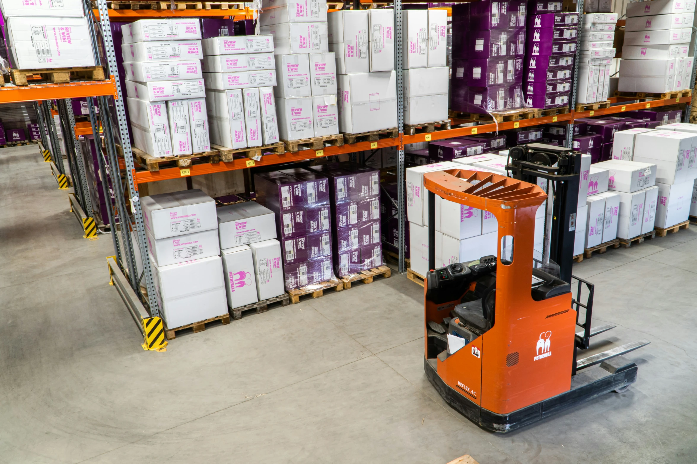 a forklift drives a large pallet through a warehouse