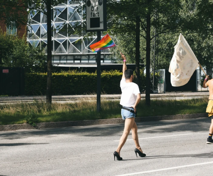 two people running across the street holding a flag