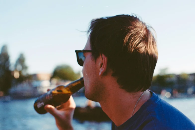 a man that is holding a bottle in his hand