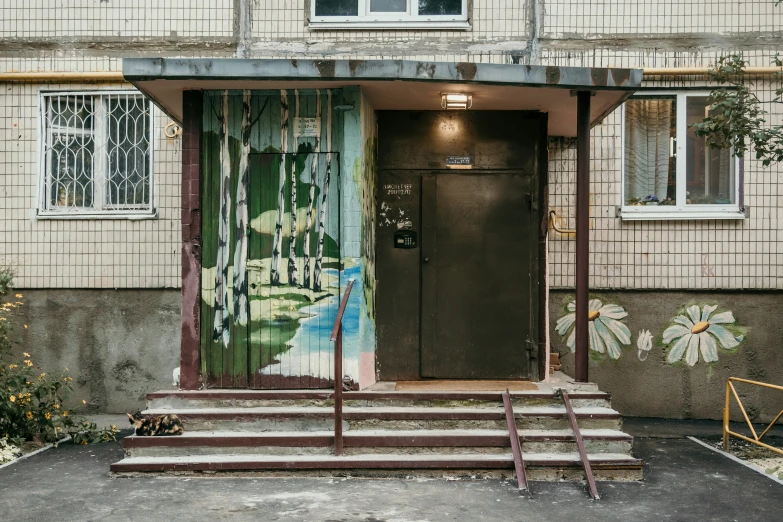 the door is open at the building with graffiti