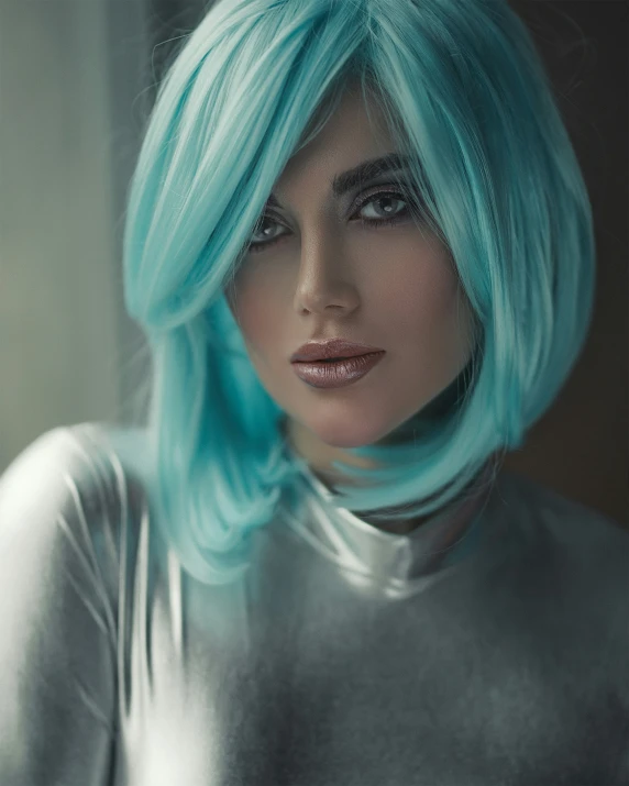 a woman with bright blue hair and silver top
