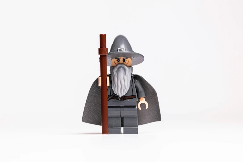 a small lego wizard with a staff