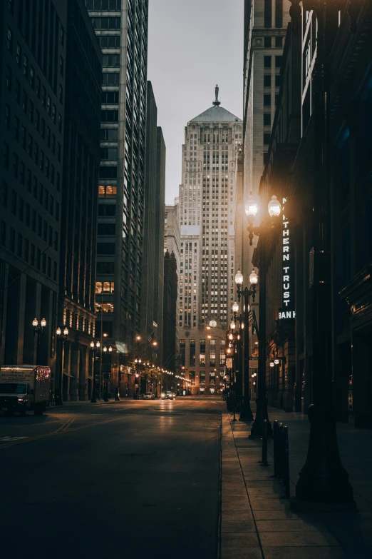 a street at night with street lamps and buildings