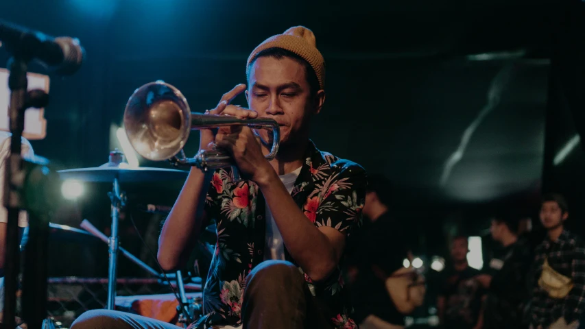 a man that is playing a trumpet in the room