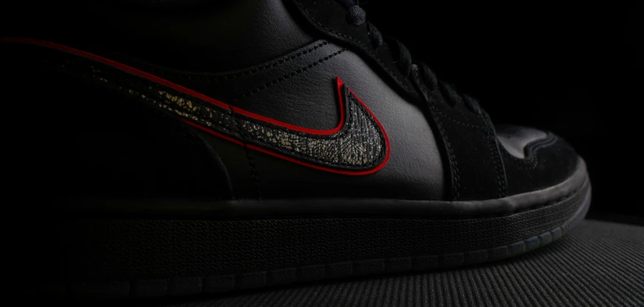 a black nike sneakers with red accents