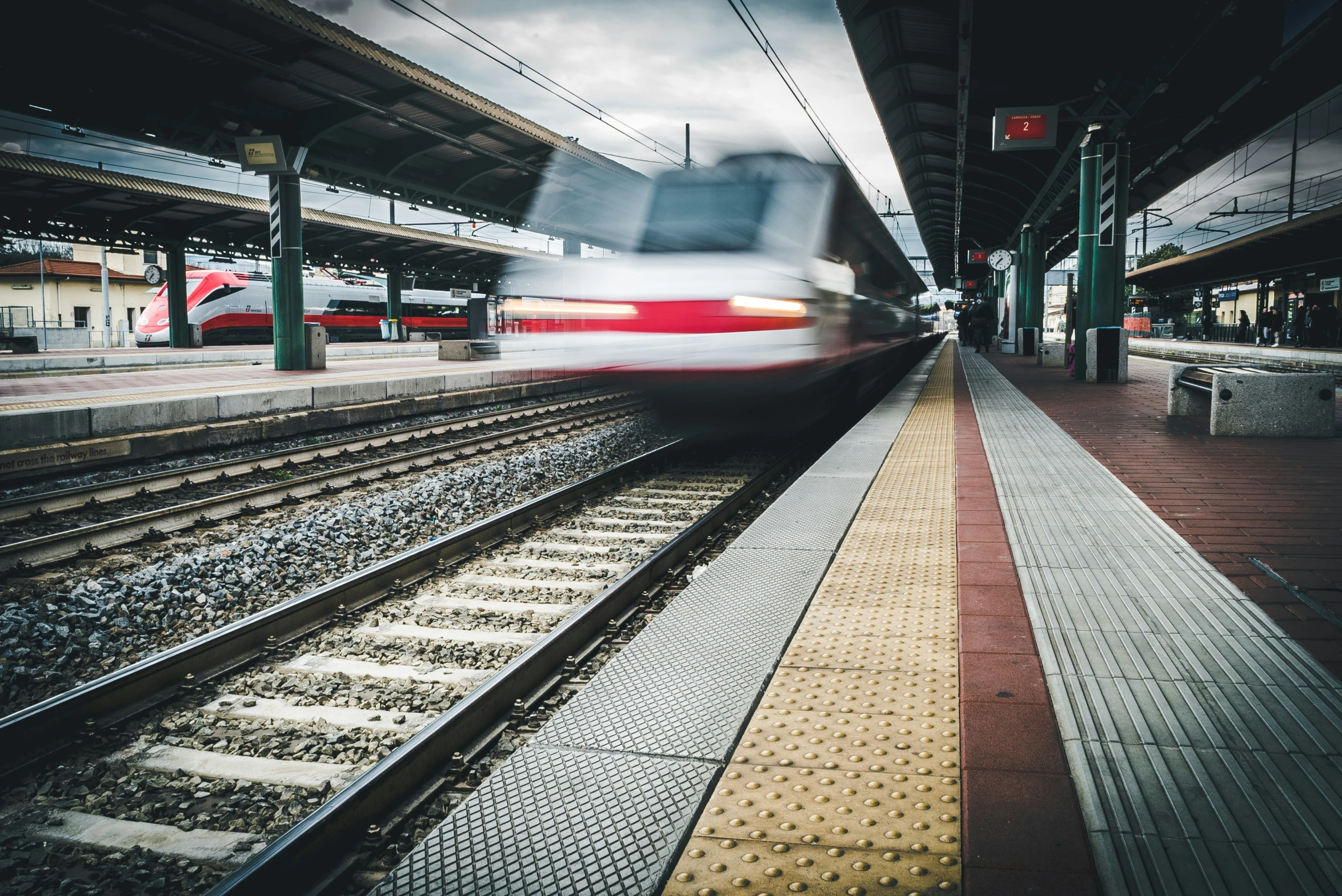 a train at a platform and its motion blur is causing