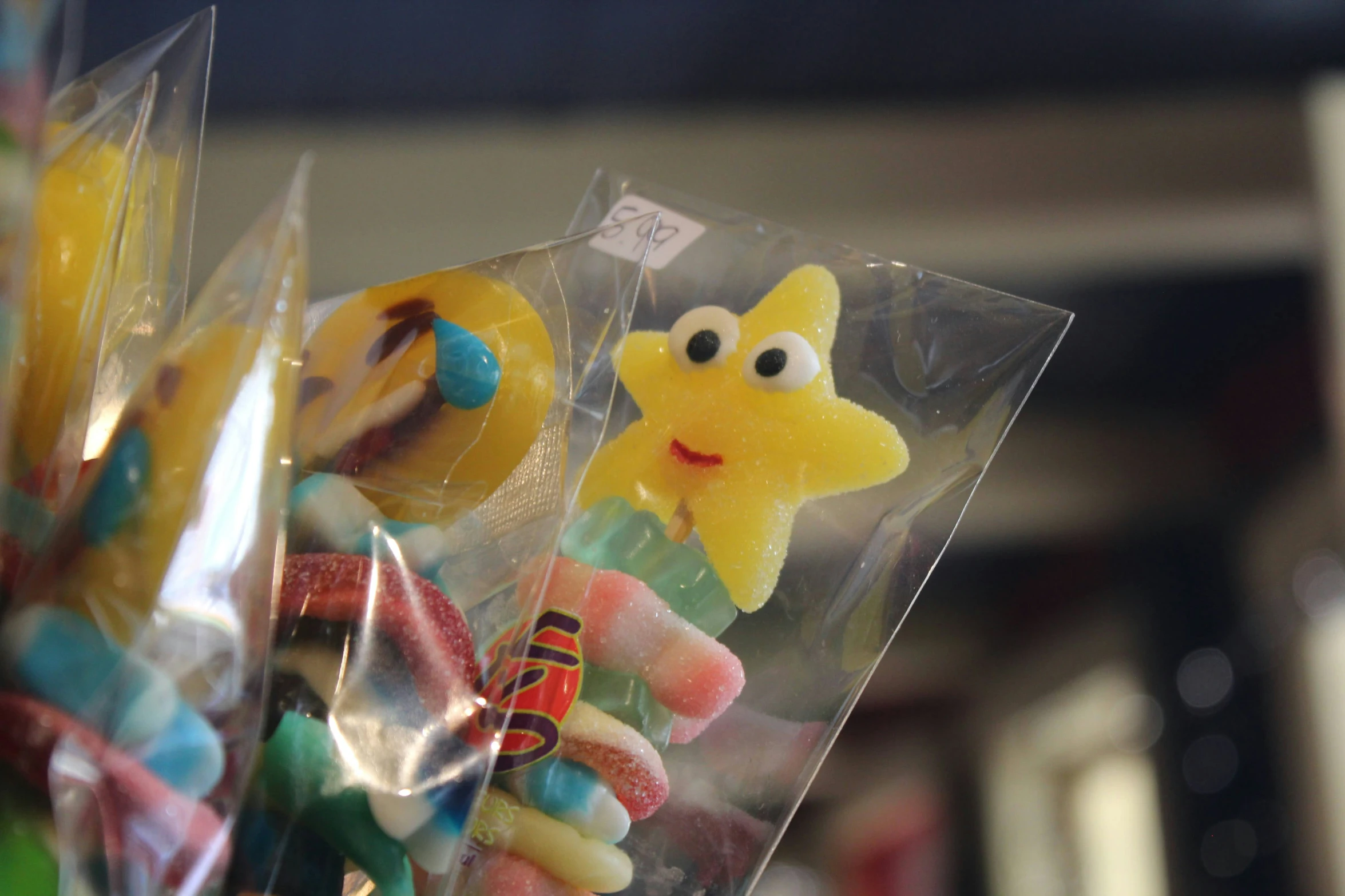 some lollipops on a glass container sitting next to some candy