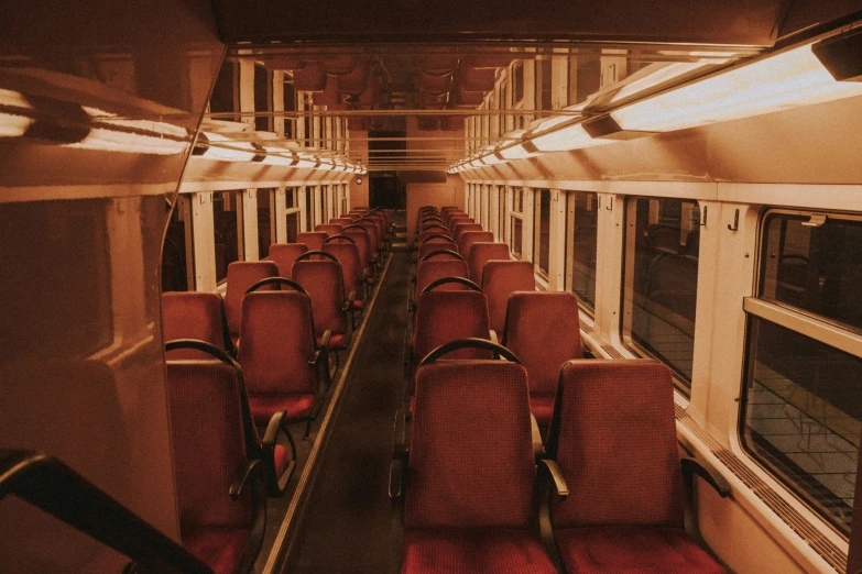 empty seats and chairs in a long train car