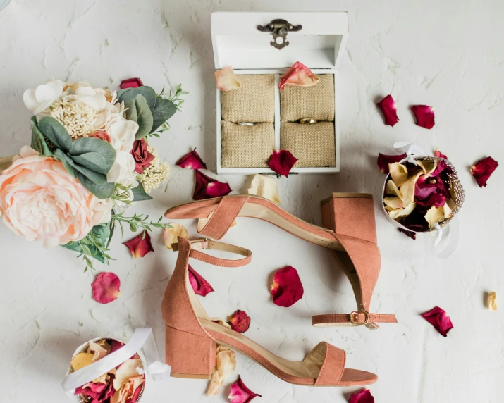 an elegant flower arrangement of flowers and flowers with some pink heels and ring