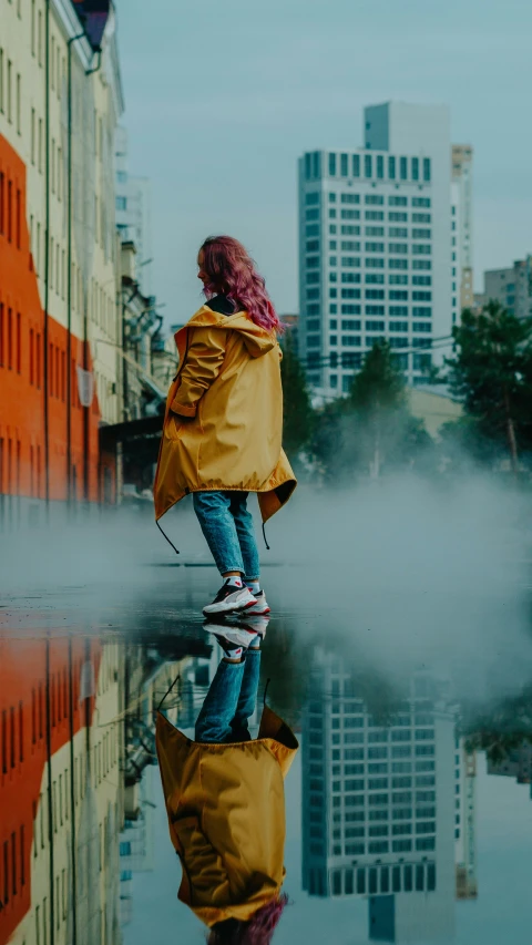 a woman standing on a sidewalk next to buildings