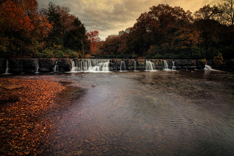 this is a view of a small waterfall in the woods