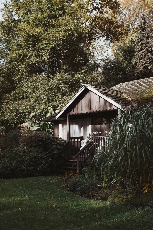 an out door cabin with trees in the background