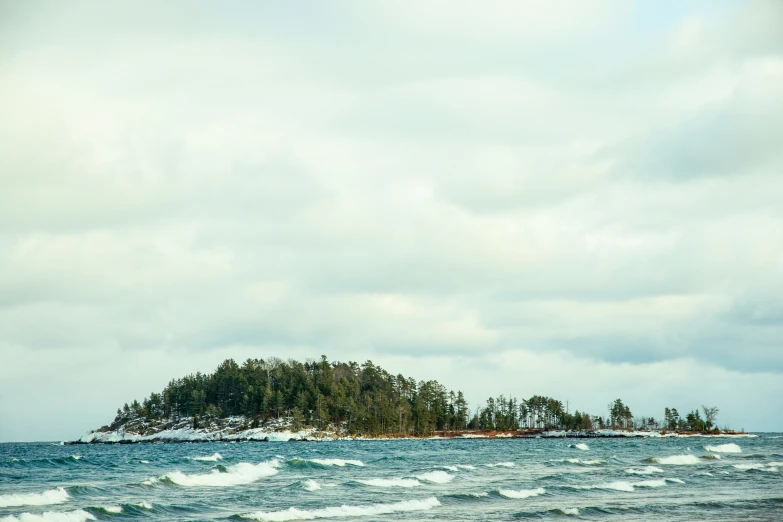 the beach is next to an island with trees