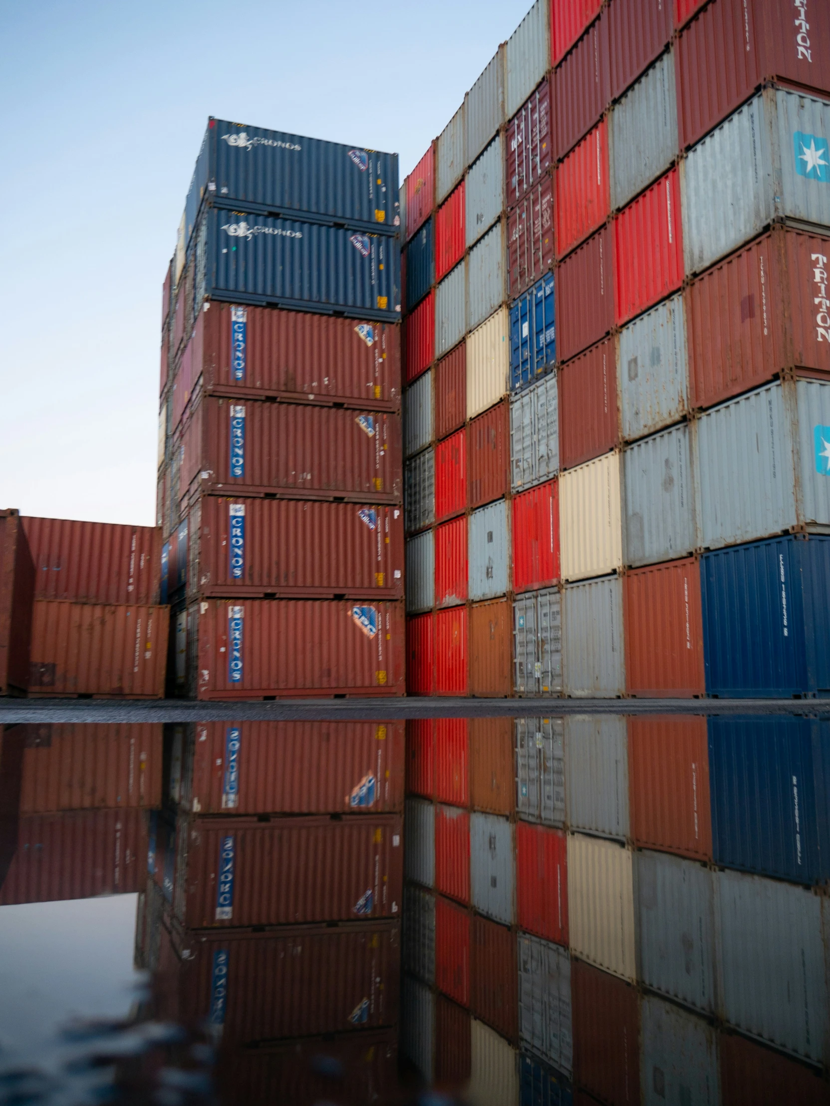 multiple stacked containers sit in the middle of water