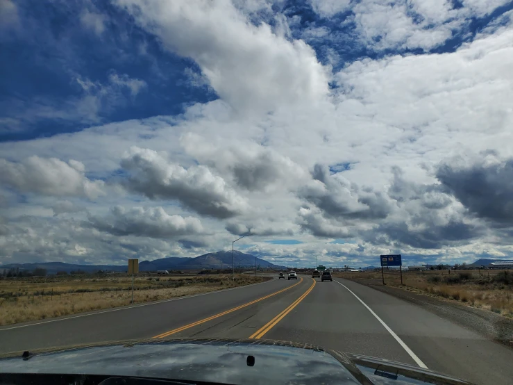 car passing on the highway with mountains in background