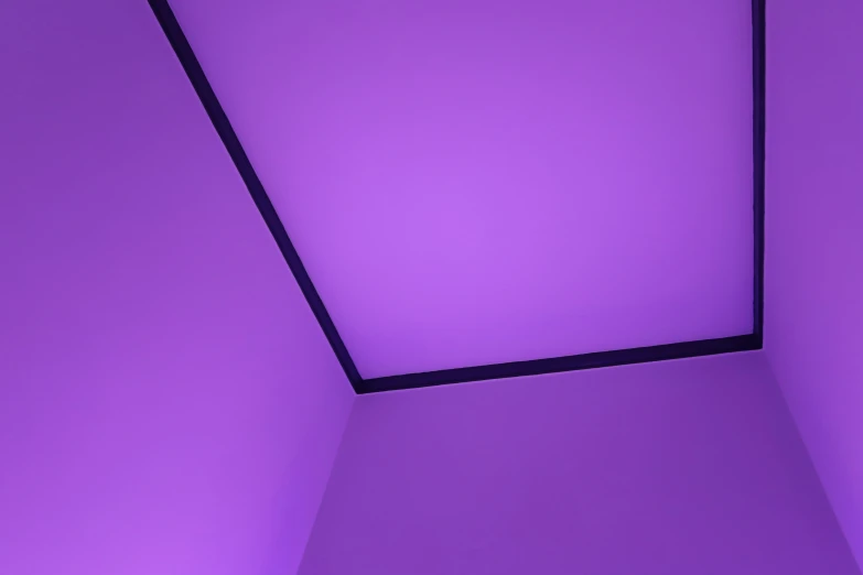 the walls are purple with a light from below