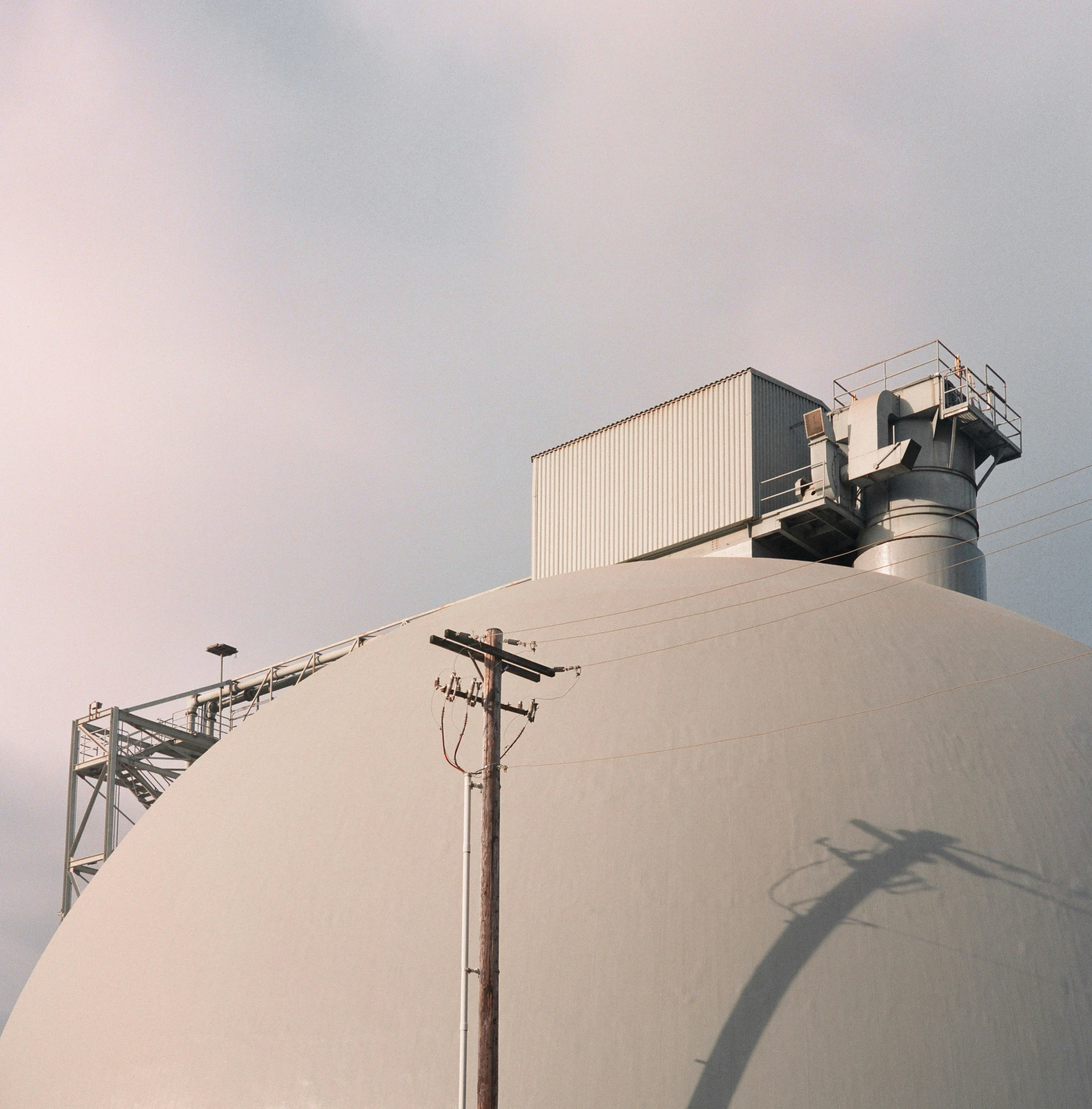 a giant white round structure with two containers on it