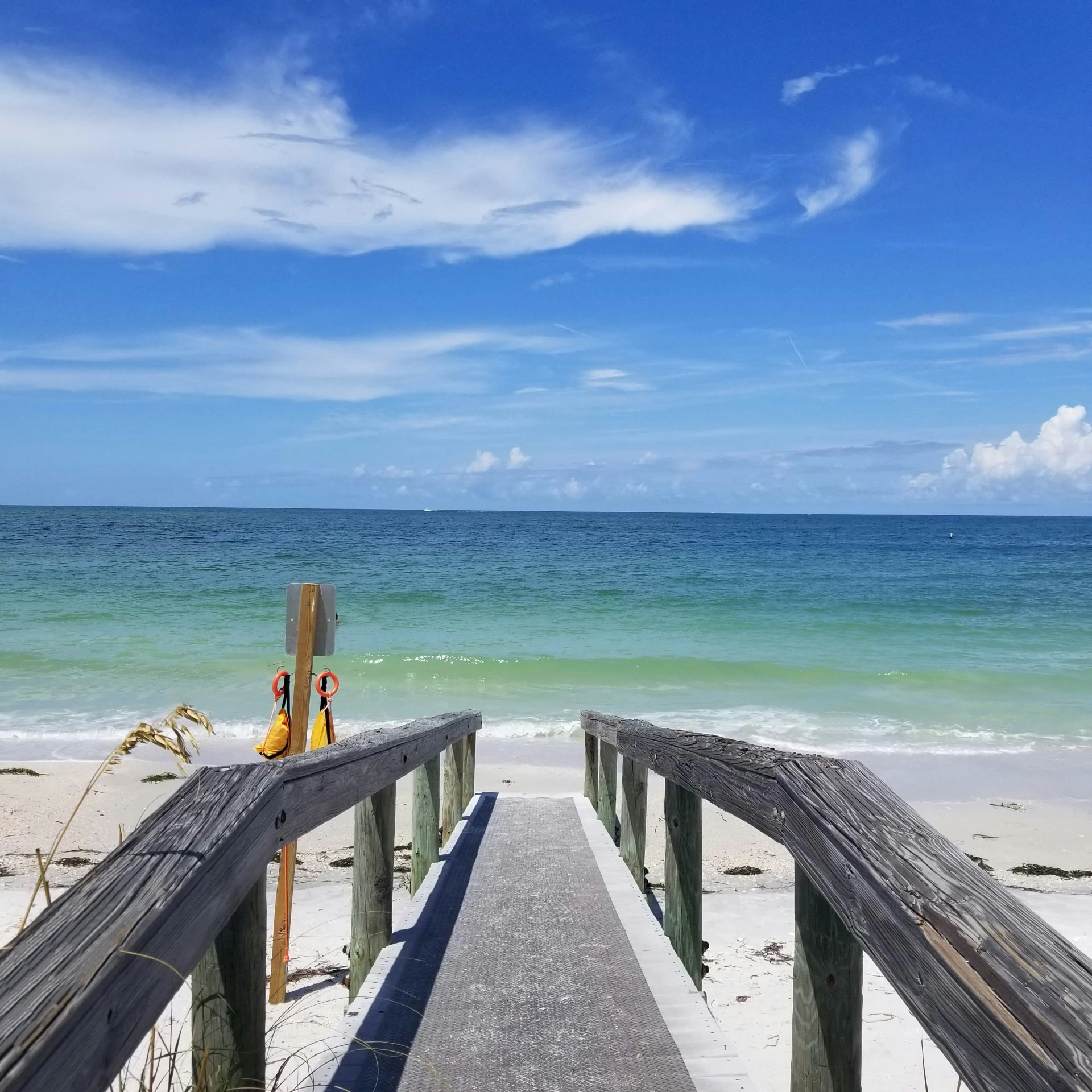 a view down the walkway to a beach