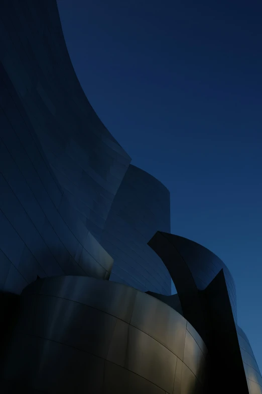 an abstract view of a very tall building with blue sky