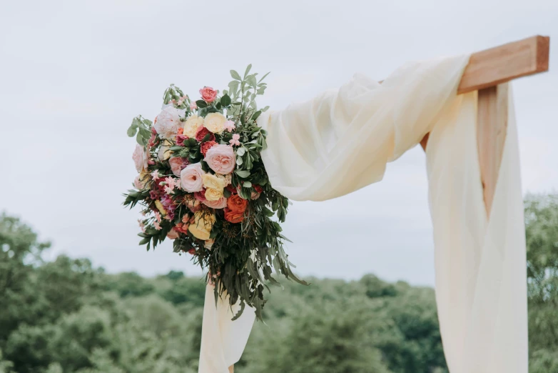 flowers are being hung over an altar with white ds