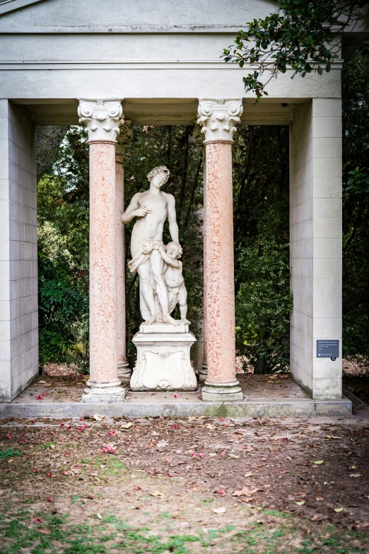 a small statue sits in front of the pillar