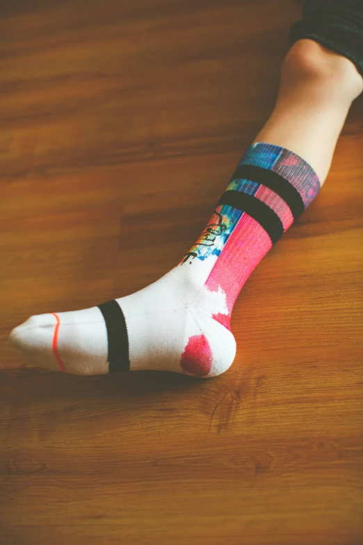 a child's legs with colorful patterned socks