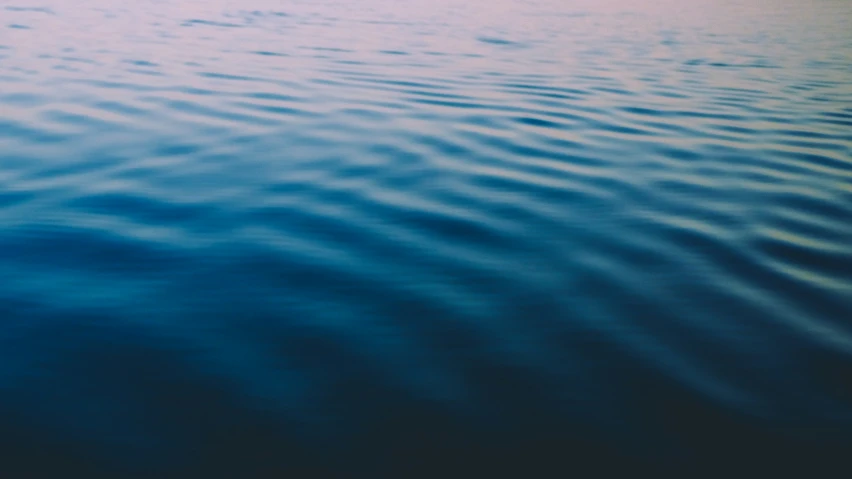 the blue sky reflecting on a body of water