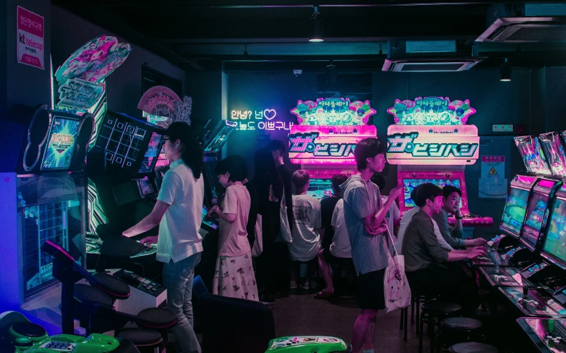 people are playing the video game at an arcade