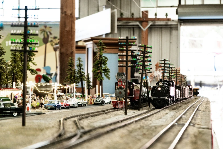 toy train on tracks next to buildings and tracks