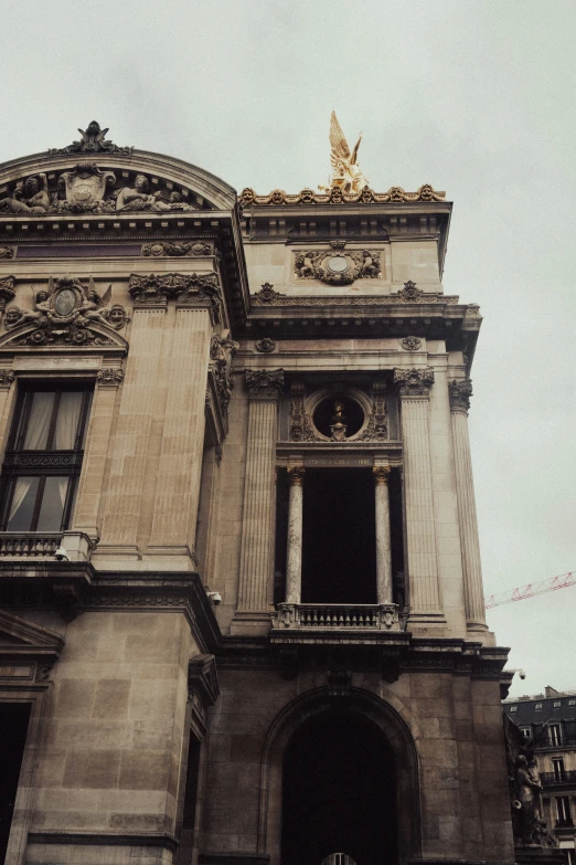 an old building with gold trim around the roof