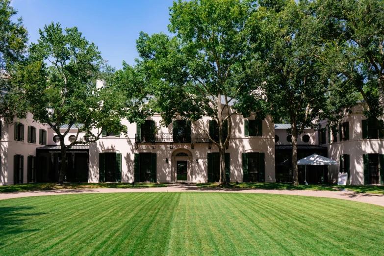 an outdoor lawn that is bordered by two large buildings